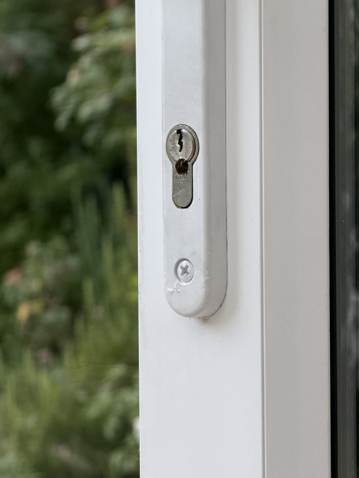 Euro cylinder lock on a UPVC conservatory door before replacement