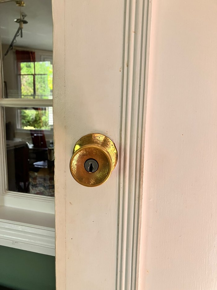 Old worn brass door knob, unused for years after the original keys were lost