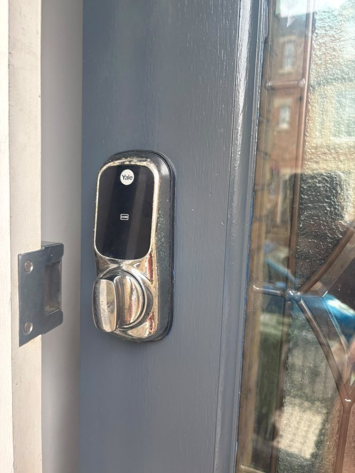 Yale smart lock keyless entry system with card access fitted to a blue front door