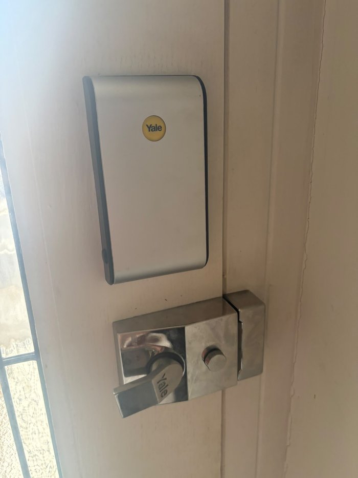 Yale smart lock keyless entry system fitted to a white front door